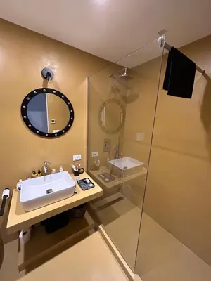 a bathroom with a sink and a shower with a mirror at Bright Apartment in San Lorenzo - Feel at Home in Rome