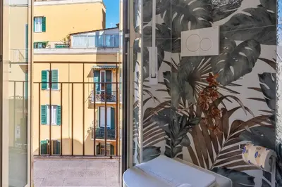 a bathroom with a toilet and a view of a building at GuestHost - AppioLatino Apartment Roma in Rome