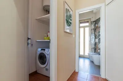 a laundry room with a washing machine and a bathroom at GuestHost - AppioLatino Apartment Roma in Rome