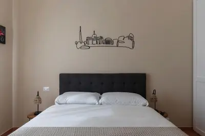 a bedroom with a bed with a black head board at GuestHost - AppioLatino Apartment Roma in Rome