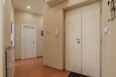 a hallway with two large doors in a room at GuestHost - AppioLatino Apartment Roma in Rome