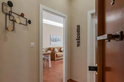 a hallway with a door leading to a living room at GuestHost - AppioLatino Apartment Roma in Rome