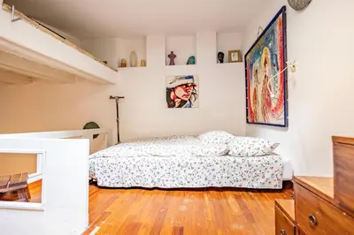 a bedroom with a bed and a wooden floor at old town Holy Door of Santa Maria Maggiore in Rome
