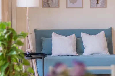 a blue couch with two white pillows on it at Luxury Maison Dei Colli in Rome