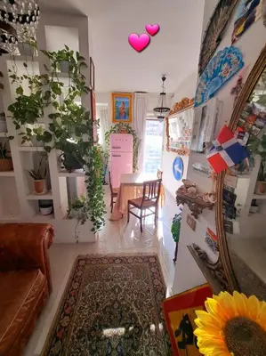 a living room with a table and some plants at Casa Serenissima Holiday Home Roma Barbara Bonanno in Rome