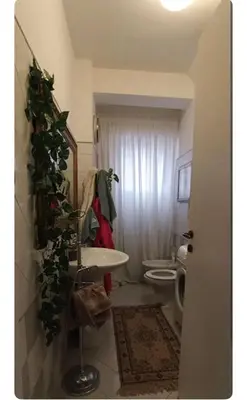 a bathroom with a sink and a christmas tree in it at Casa Serenissima Holiday Home Roma Barbara Bonanno in Rome