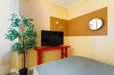 a room with a tv and a red table with a television at BDC - The ancient Aqueduct in Rome