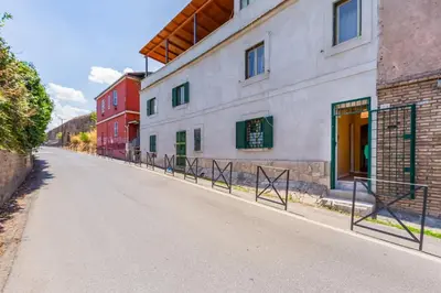 an empty street in front of a building at BDC - The ancient Aqueduct in Rome
