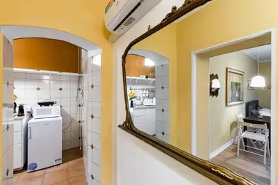 a kitchen with yellow walls and a mirror at BDC - The ancient Aqueduct in Rome
