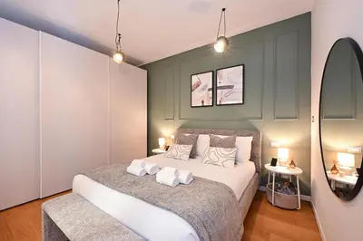 a bedroom with a large bed with two pillows at Monti luxury patio apartment in Rome