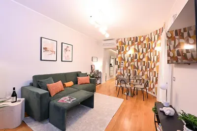 a living room with a green couch and a table at Monti luxury patio apartment in Rome