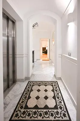 a hallway with a black and white rug on the floor at Monti luxury patio apartment in Rome