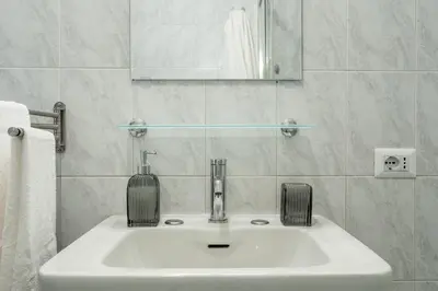 a white sink in a bathroom with a mirror at Domus Bonadies - Musei Vaticani - San Pietro in Rome