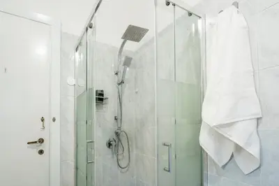 a bathroom with a shower with a glass door at Domus Bonadies - Musei Vaticani - San Pietro in Rome