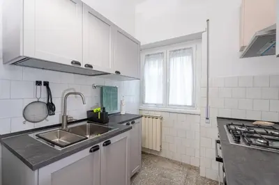 a kitchen with white cabinets and a sink at Domus Bonadies - Musei Vaticani - San Pietro in Rome