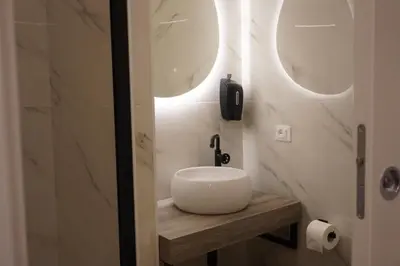 a bathroom with a sink and two mirrors at Tito Livio Vatican Home in Rome