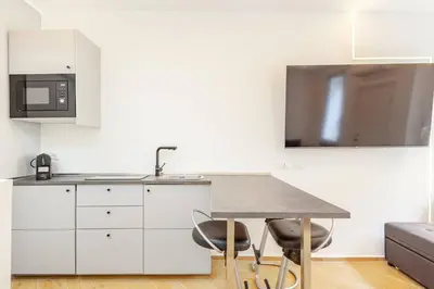 a kitchen with a table and a microwave at Tito Livio Vatican Home in Rome