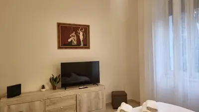 a living room with a flat screen tv on a wooden cabinet at At the Pope's bridge in Rome