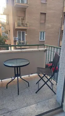 a table and a chair on a balcony at At the Pope's bridge in Rome