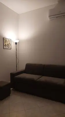 a living room with a couch and a lamp at At the Pope's bridge in Rome