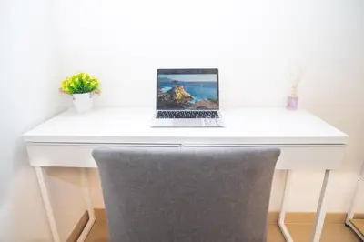 a white desk with a laptop on it at Modern two-room apartment for 2, 20 minutes from Termini in Rome