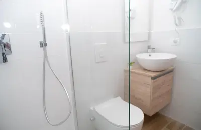 a bathroom with a shower and a toilet and a sink at Modern two-room apartment for 2, 20 minutes from Termini in Rome
