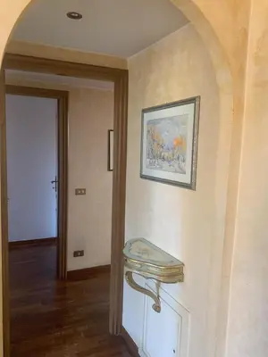 a hallway with a table and a painting on the wall at Milizie Vintage in Rome