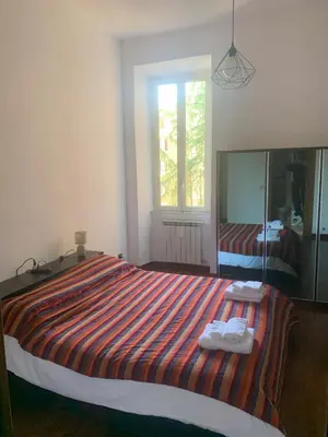 a bedroom with a large bed with towels on it at Milizie Vintage in Rome
