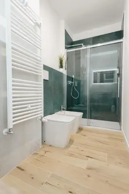 a bathroom with a tub and a toilet and a shower at Smeraldo Vatican Moments in Rome