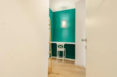 a hallway with a green wall and a stool at Smeraldo Vatican Moments in Rome