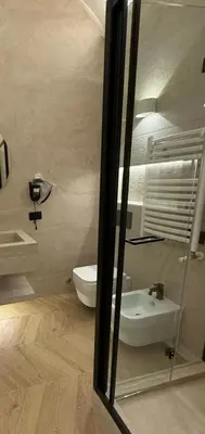 a bathroom with a toilet and a sink and a mirror at Residenza Vittorio Veneto in Rome