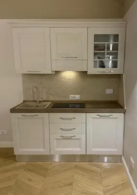 a kitchen with white cabinets and a sink at Residenza Vittorio Veneto in Rome