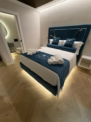a bedroom with a large bed with towels on it at Residenza Vittorio Veneto in Rome
