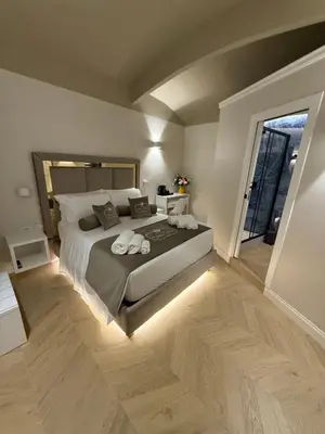 a bedroom with a large bed and a large window at Residenza Vittorio Veneto in Rome