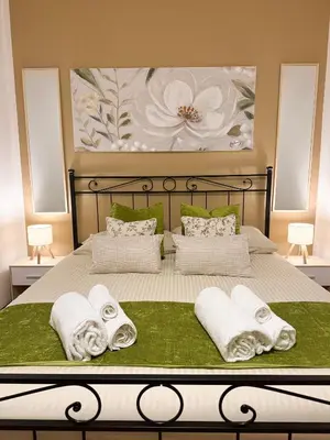 a bed with towels and a painting on the wall at NEW! St Peter Roman holidays 1953 in Rome