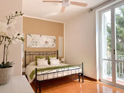 a bedroom with a bed and a ceiling fan at NEW! St Peter Roman holidays 1953 in Rome