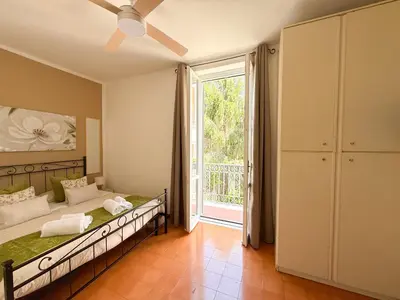 a bedroom with a bed and a large window at NEW! St Peter Roman holidays 1953 in Rome
