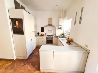 a kitchen with white cabinets and a white refrigerator at Boutique Domus Charme Trastevere Vascellari in Rome