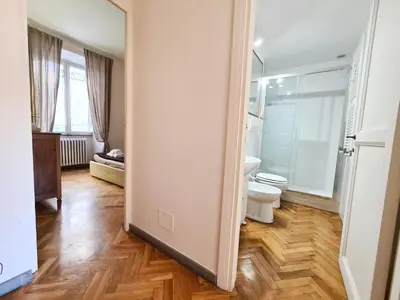 a bathroom with a toilet and a sink and a mirror at Boutique Domus Charme Trastevere Vascellari in Rome
