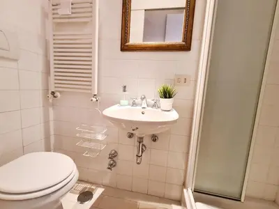a bathroom with a toilet and a sink at Boutique Domus Charme Trastevere Vascellari in Rome