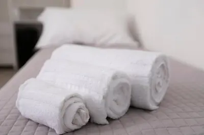 a pile of rolled towels on a bed at Elegant Flat in Ponte Milvio in Rome