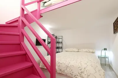 a pink staircase in a bedroom with a bed at Walking in the center of Rome in Rome