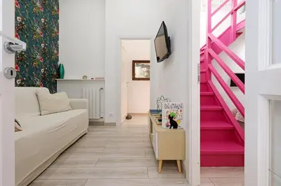 a living room with a couch and pink stairs at Walking in the center of Rome in Rome