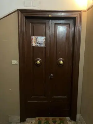 a wooden door with a sign on it in a room at Walking in the center of Rome in Rome