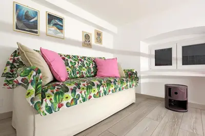 a living room with a couch and a window at Walking in the center of Rome in Rome