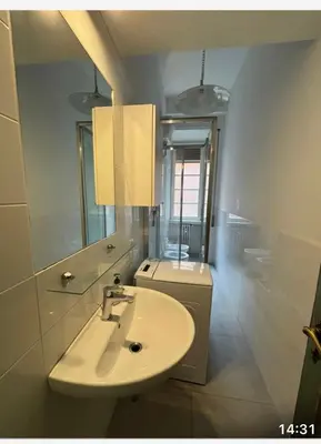 a white bathroom with a sink and a toilet at Sabo rooms in Rome