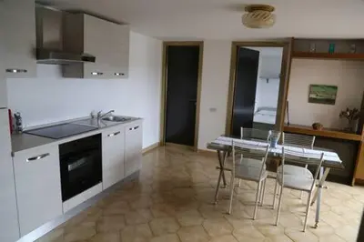 a kitchen with a table and a table and chairs at Super attico Eur in Rome