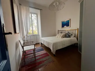 a bedroom with a bed and a window at Domus Ele in Rome
