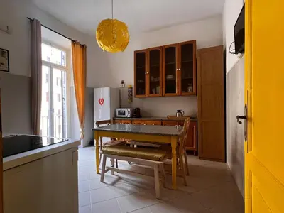 a kitchen with a table and a dining room at Domus Ele in Rome