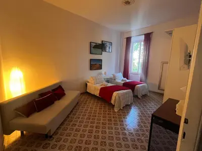 a living room with two beds and a couch at Domus Ele in Rome